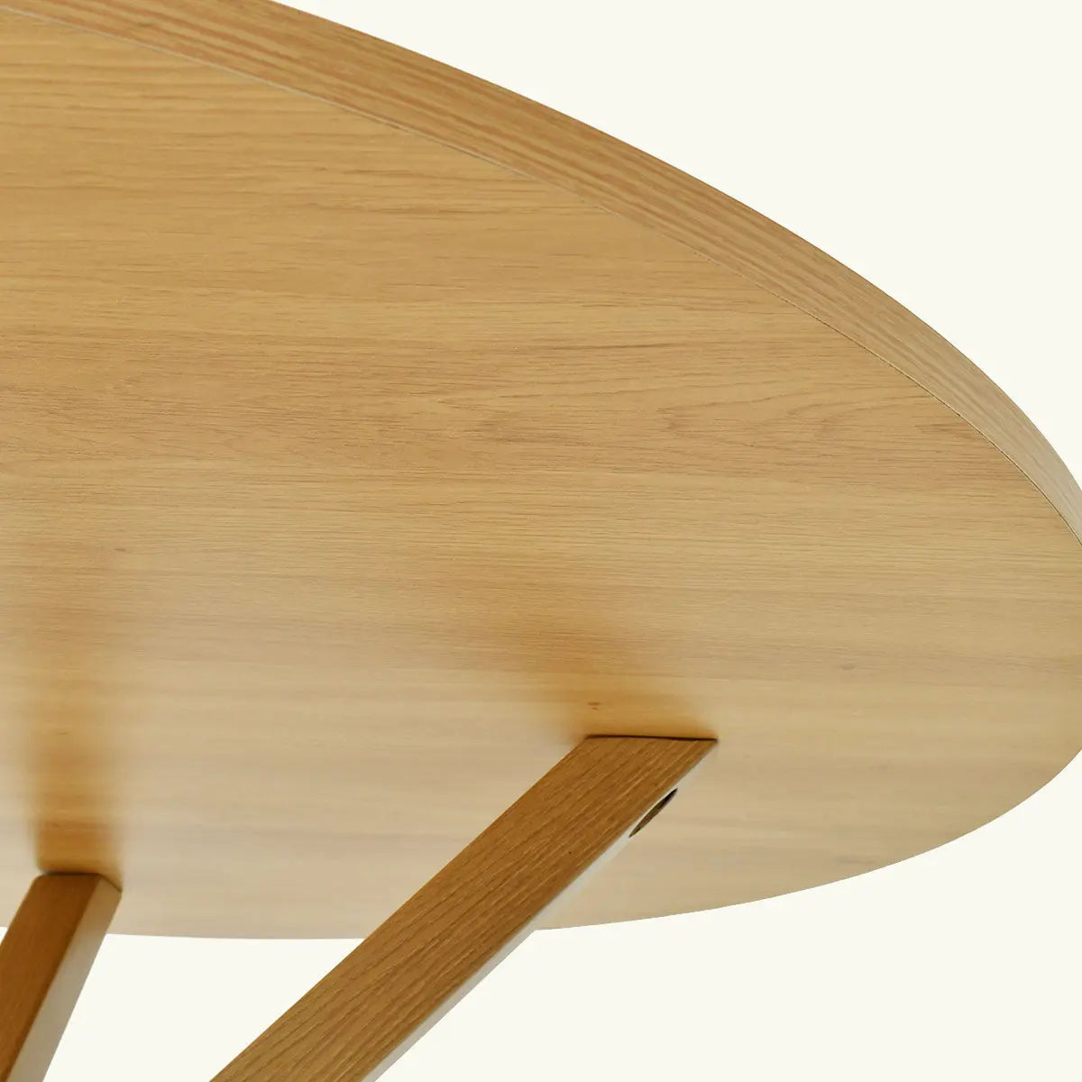 Close-up of Oliver Modern Round Dining Table, wooden finish, in contemporary style, neutral setting.