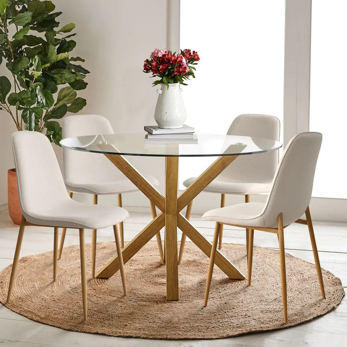 Oliver & Oslo 39" Glass Round Dining Table Set with cream chairs, wooden legs, and jute rug.