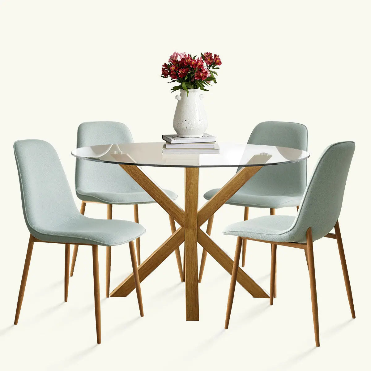 Oliver & Oslo Glass Round Dining Table Set with wooden legs and light mint chairs in dining area.