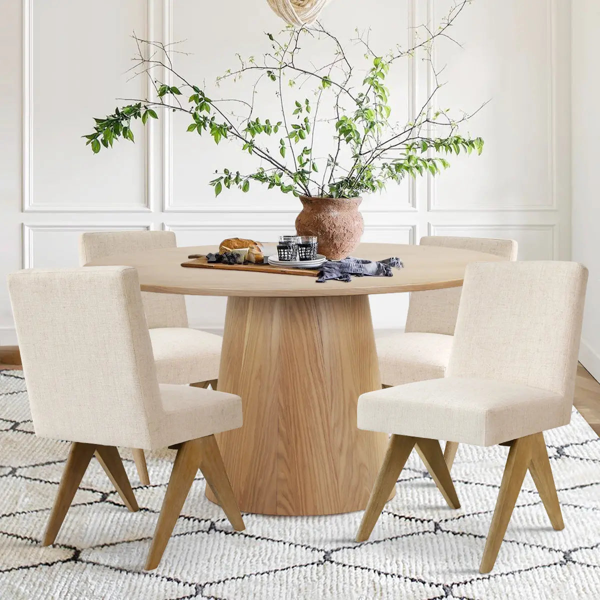 Orchid & Morgan oak dining set, beige chairs, white paneled walls, geometric rug, elegant dining room.