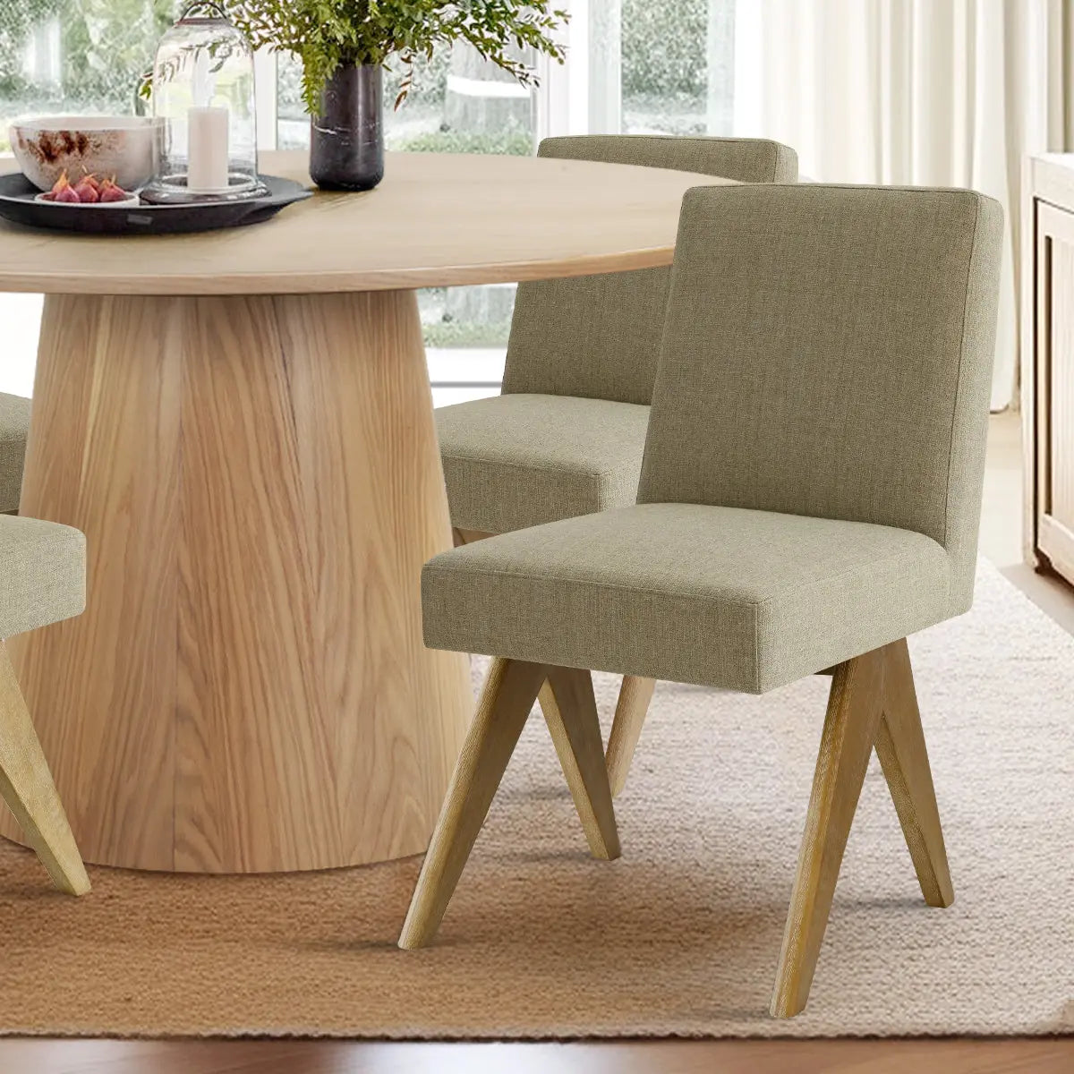 Orchid & Morgan oak round dining table set with beige chairs on carpet, modern dining room.