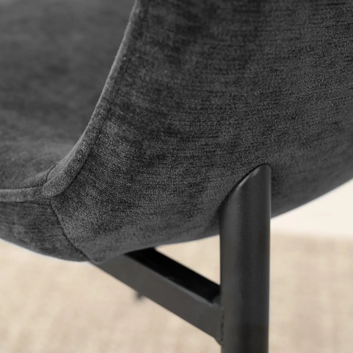 Black Oslo Modern Chair Upholstered Metal Legs Detail in Dining Room with Neutral Rug.