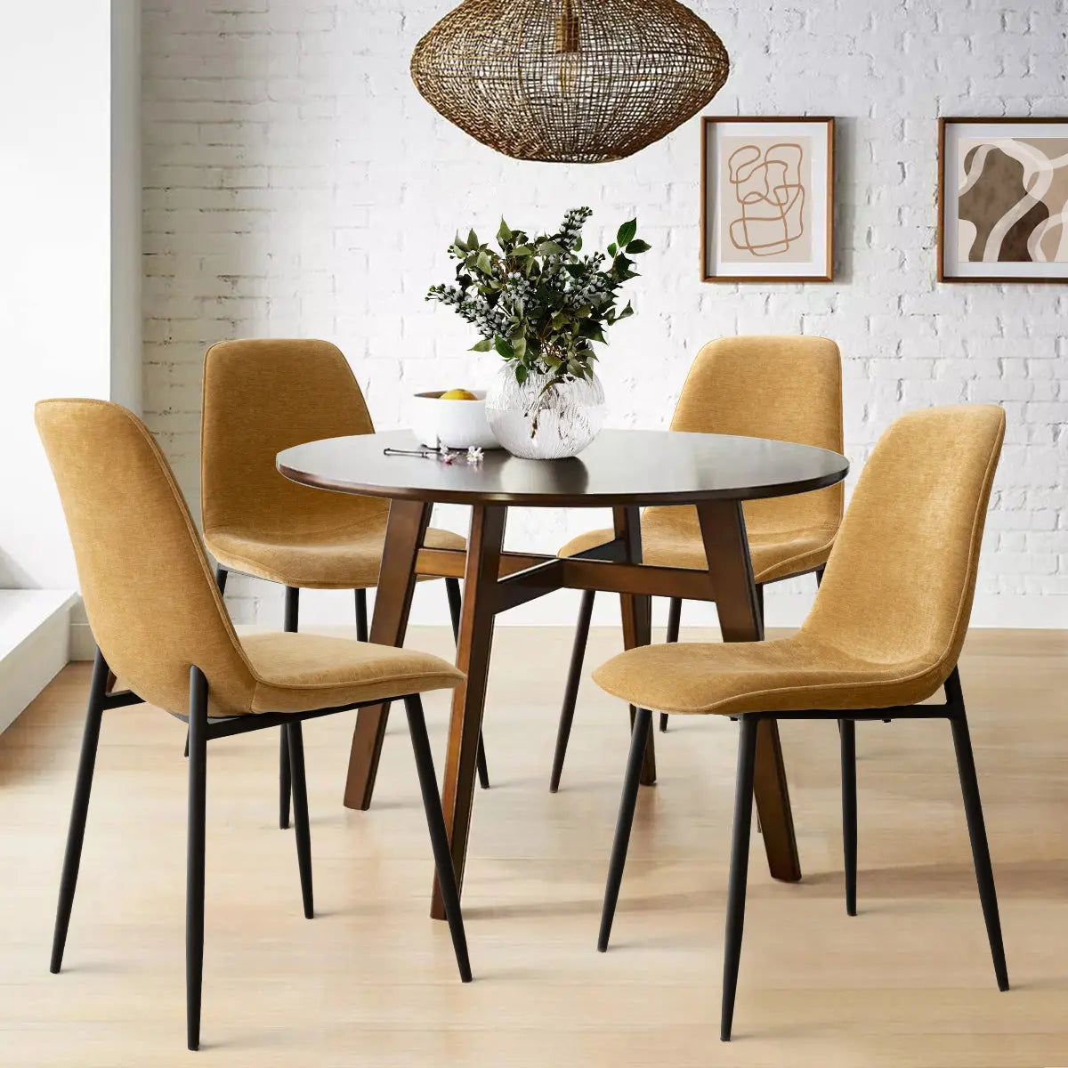 Modern dining room with Oslo upholstered chairs, metal legs, round table, light wood floor, and artwork.