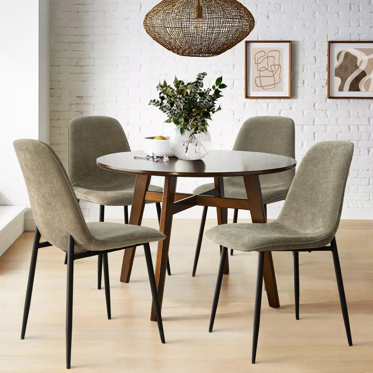 Oslo Modern Upholstered Dining Chair with metal legs, round table, white brick wall, light wood flooring.