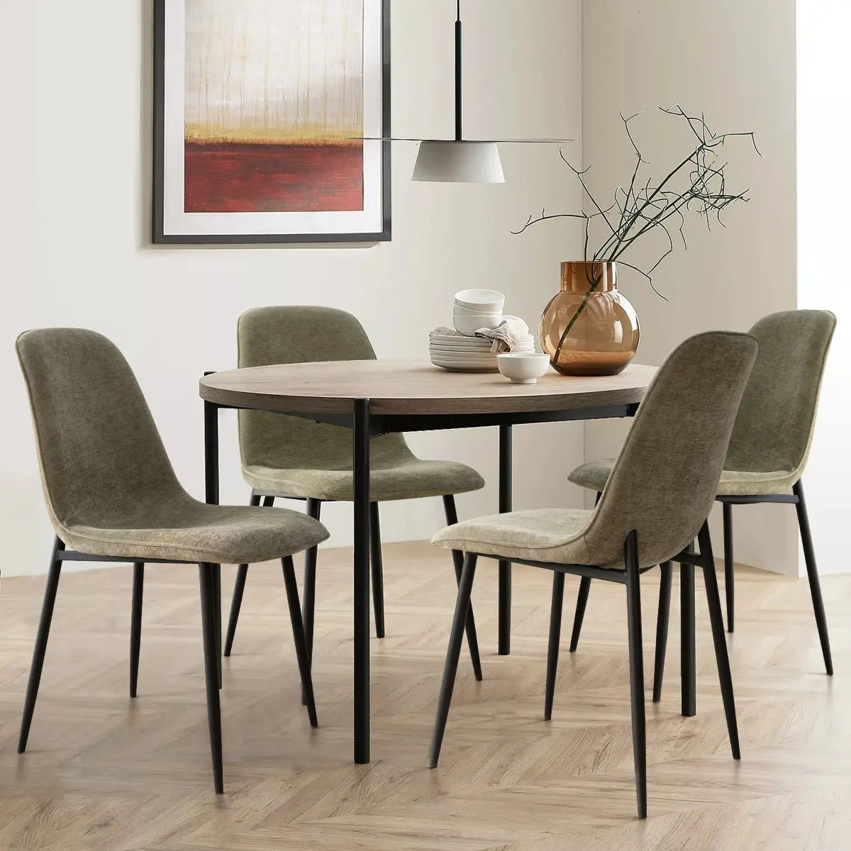 Oslo Modern Dining Chair with metal legs in cozy dining room, neutral walls, herringbone wood flooring.