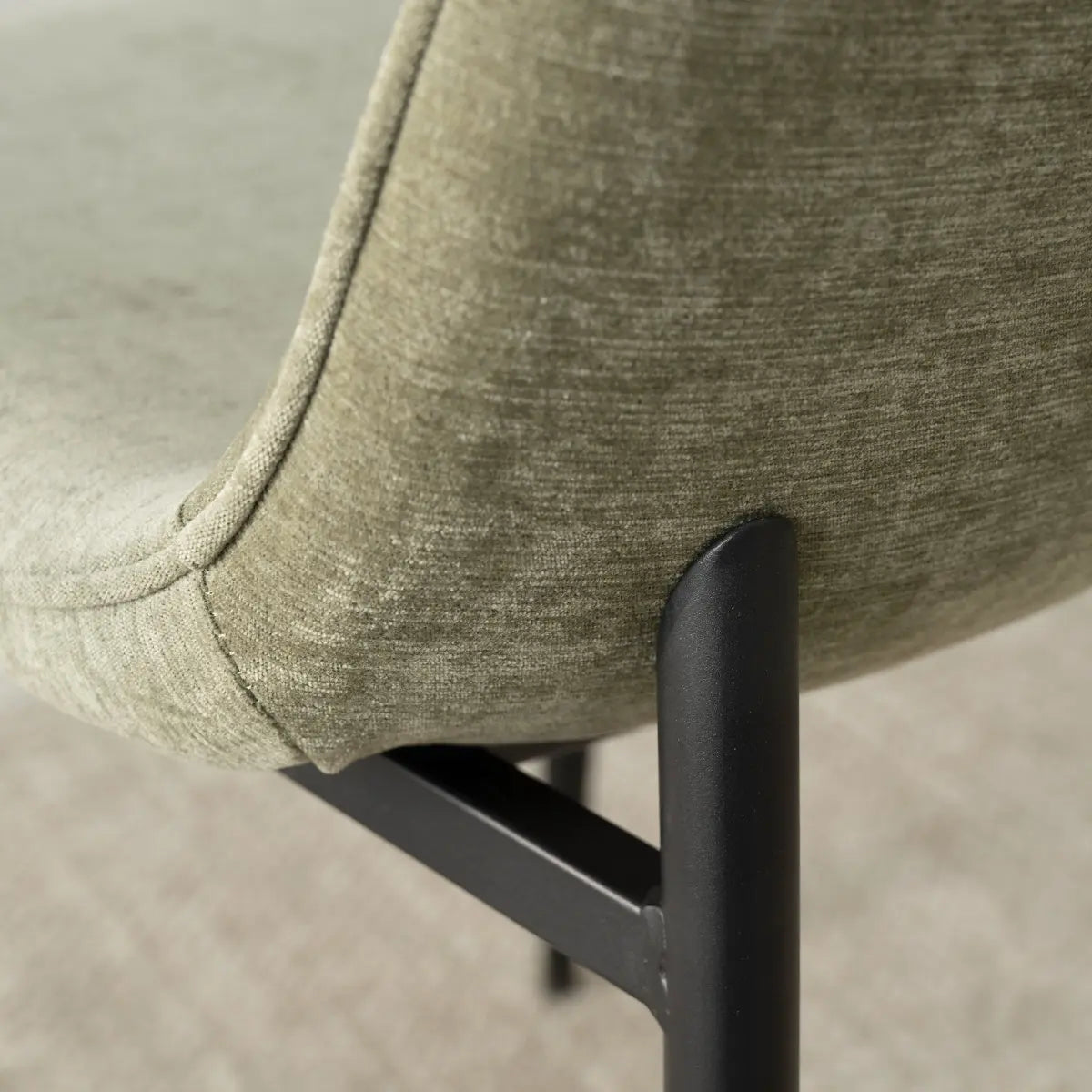 Oslo Modern Upholstered Dining Chair, metal legs, green fabric, close-up, minimalist design detail.