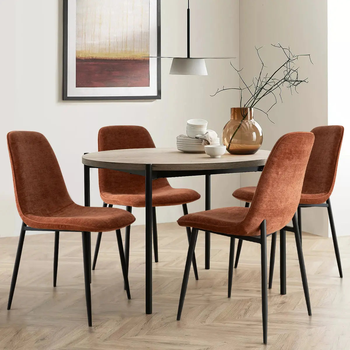 Oslo Modern Dining Chair with Metal Legs, round table, herringbone floor, abstract wall art.