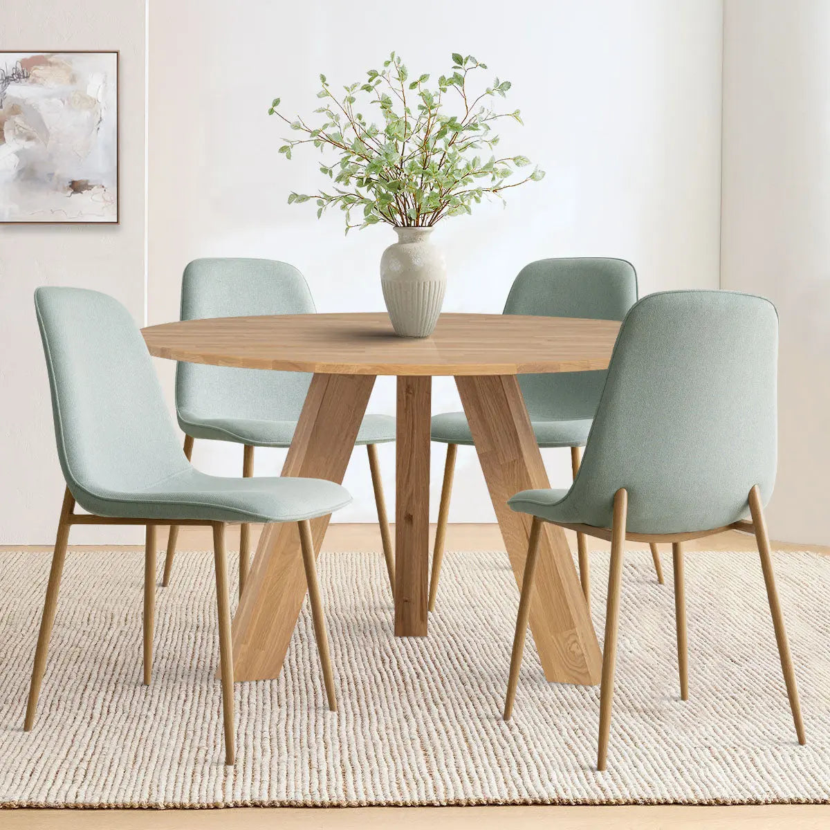 Oslo Modern Chenille Dining Chair with oak legs, round wood table, beige rug in dining room.