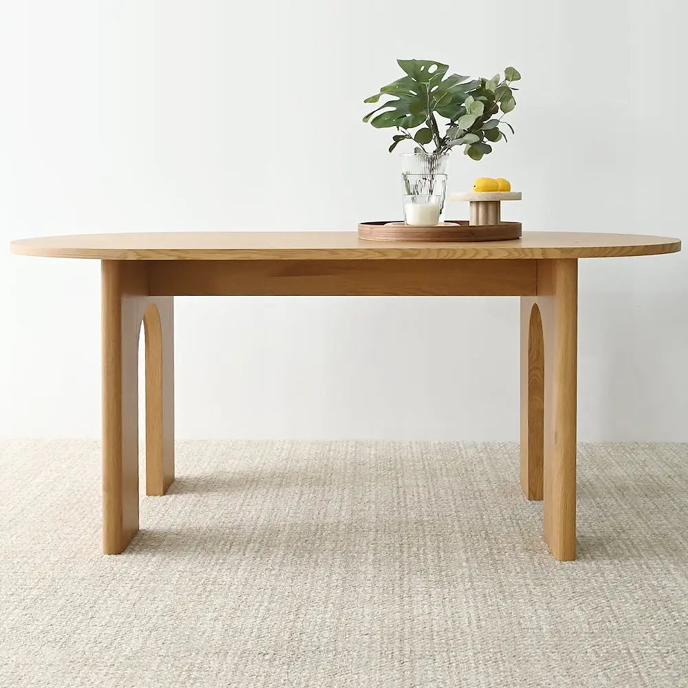 Roma Modern Oval Dining Table in neutral room with textured flooring, minimalist design.