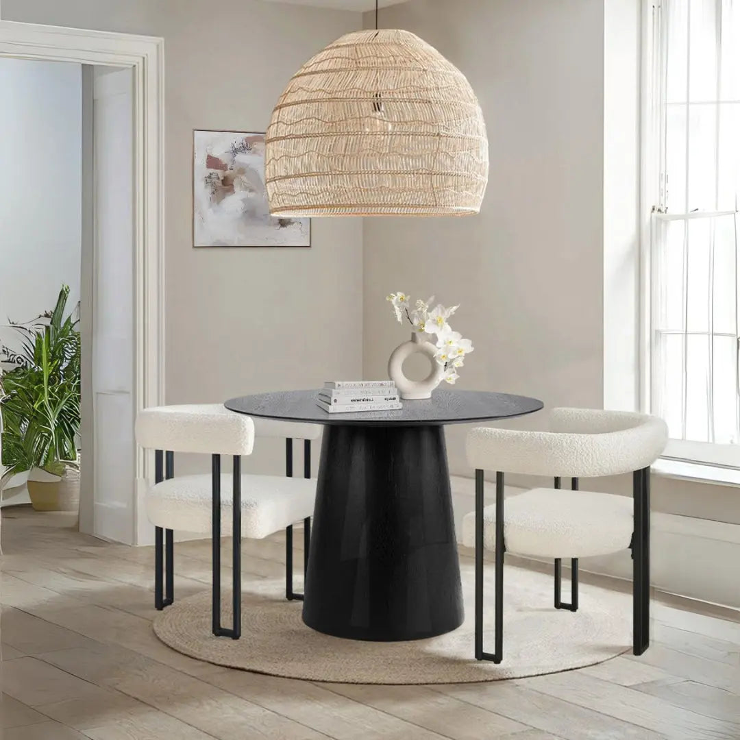 Saigong Oak Round Dining Table in modern dining room with beige walls, light wood flooring, and rattan lamp.