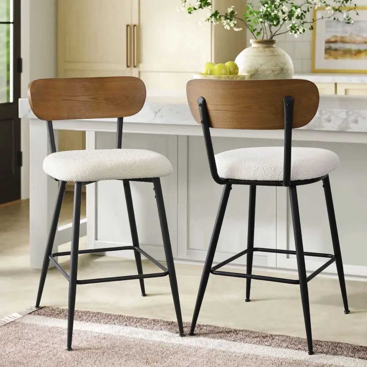 Skagen 27" Beige Boucle Counter Stool Set in kitchen with gray rug, white cabinets, and marble island.