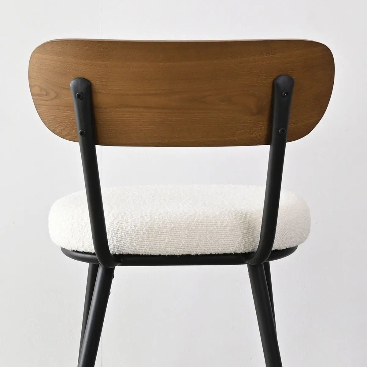 Skagen Beige Boucle Counter Stool, ash back, black legs, in minimalist room setup.