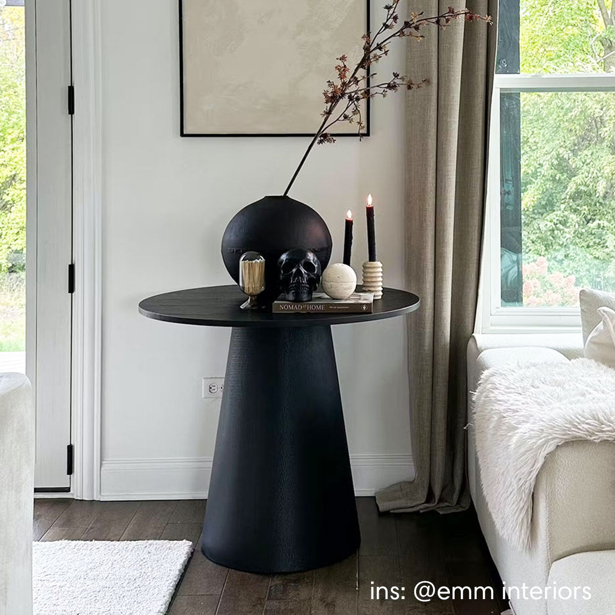 Dwen Modern Round Pedestal Dining Table in elegant living room, dark wood flooring, neutral decor.