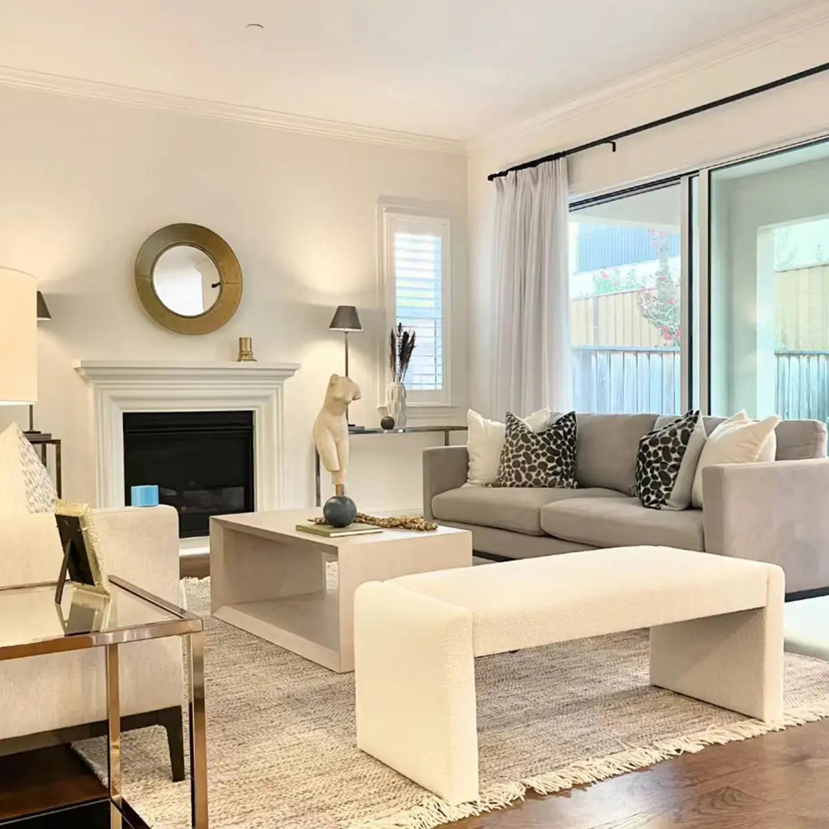 Kaia Modern Beige Upholstered Waterfall Bench in stylish living room with gray sofa and hardwood floor.