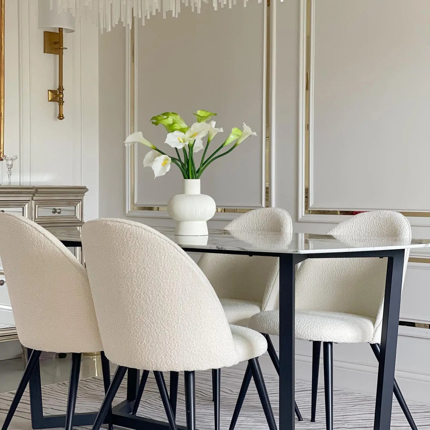 Elegant dining room featuring Rhon Modern Boucle Upholstered Dining Chairs, glass table, neutral walls.