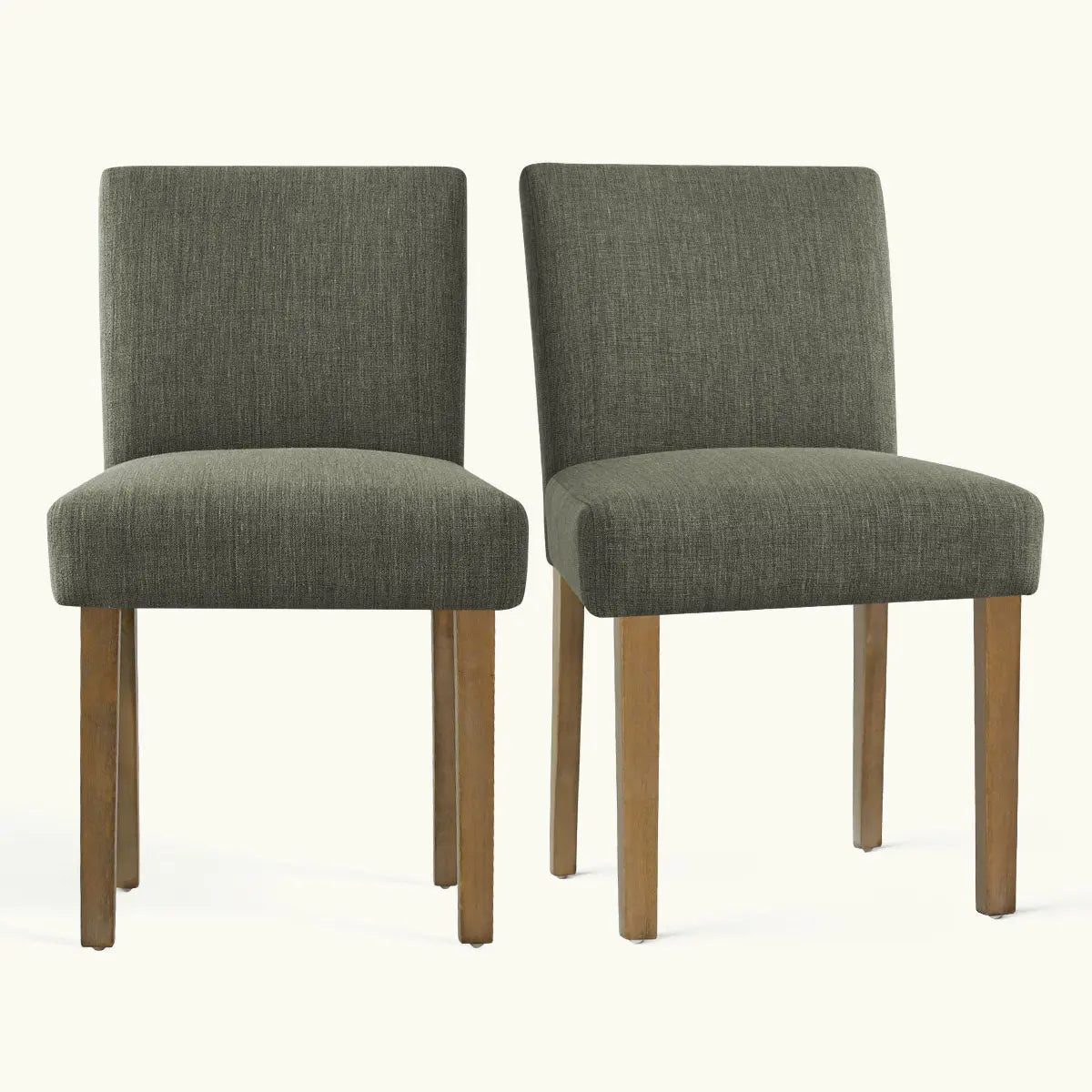 Two green North Upholstered Dining Chairs with wood legs on light background, highlighting modern design.