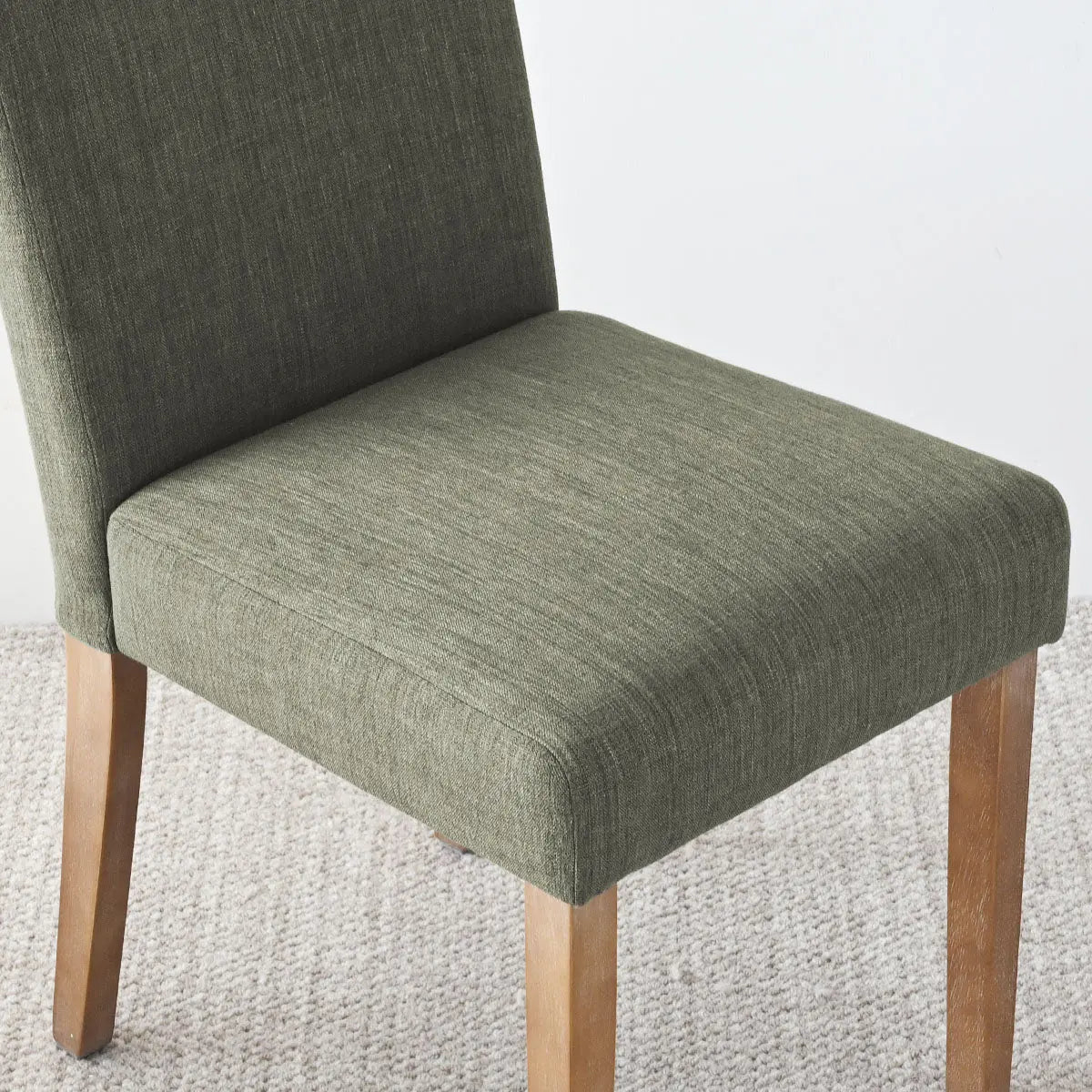 North Upholstered Dining Chair, green fabric, wood legs, neutral carpet, modern dining room furniture.