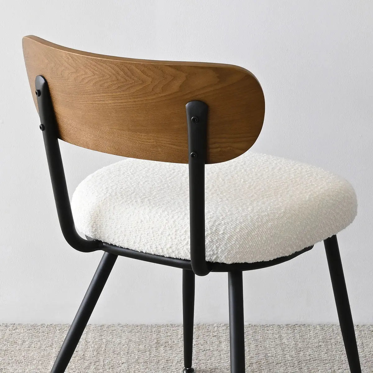 Skagen Beige Boucle Dining Chair with Ash Back, modern design, carpeted floor, sleek black frame.