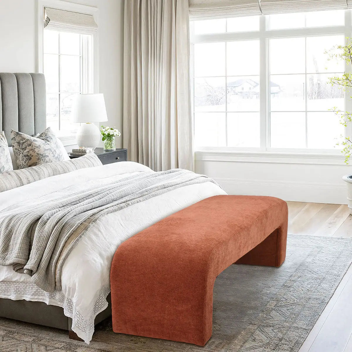 Bedroom with Lily Chenille Accent Waterfall Bench, gray upholstered bed, wood flooring, and soft neutral decor.