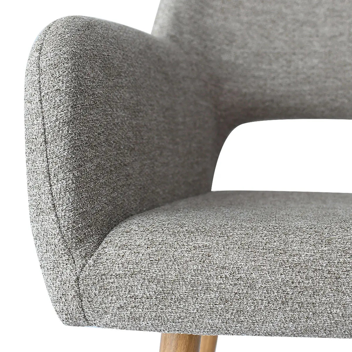 Close-up of a grey upholstered stool with arms, wooden legs, modern design.