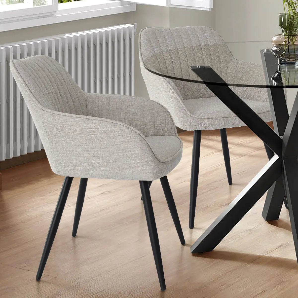 Boston Modern Upholstered Dining Chairs in neutral fabric on wooden floor, near glass table.