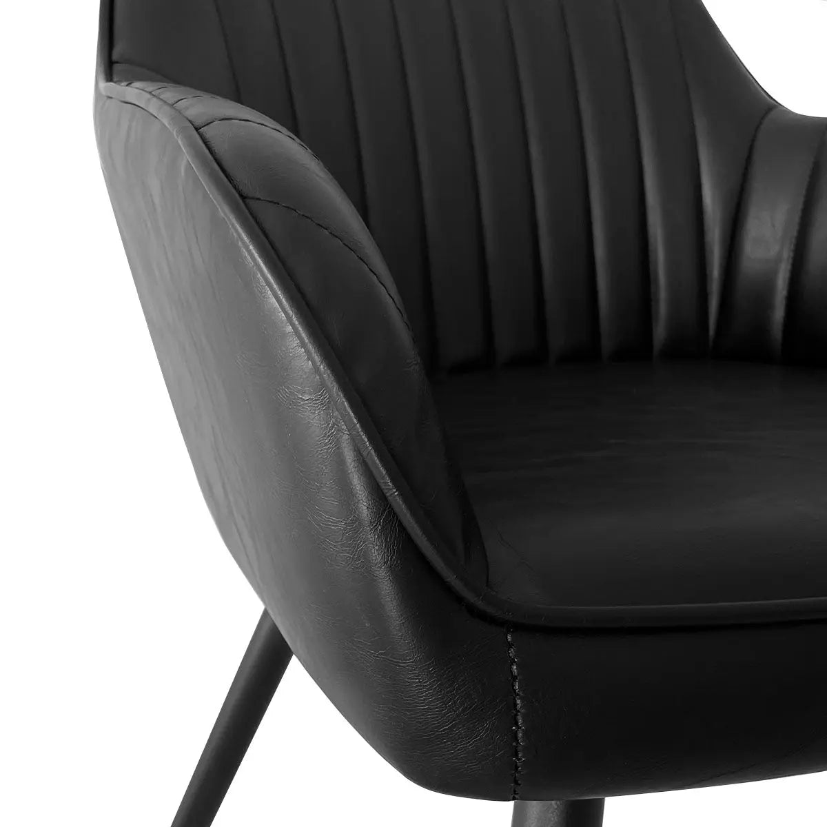 Close-up of black Boston Leather Upholstered Dining Chair with Arms, quilted leather detailing visible.