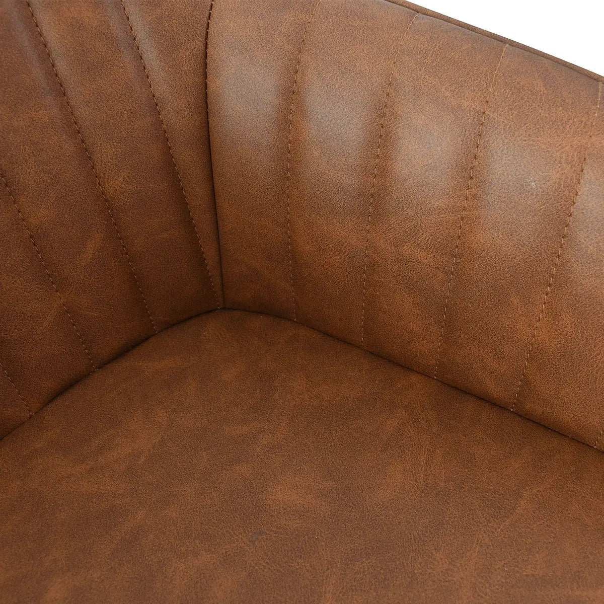 Close-up of brown leather upholstery on dining chair with arms, showing stitching detail.