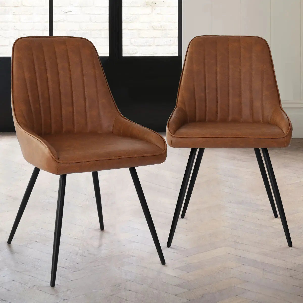 Boston Leather Upholstered Dining Chair with sleek black legs on light wood herringbone flooring.