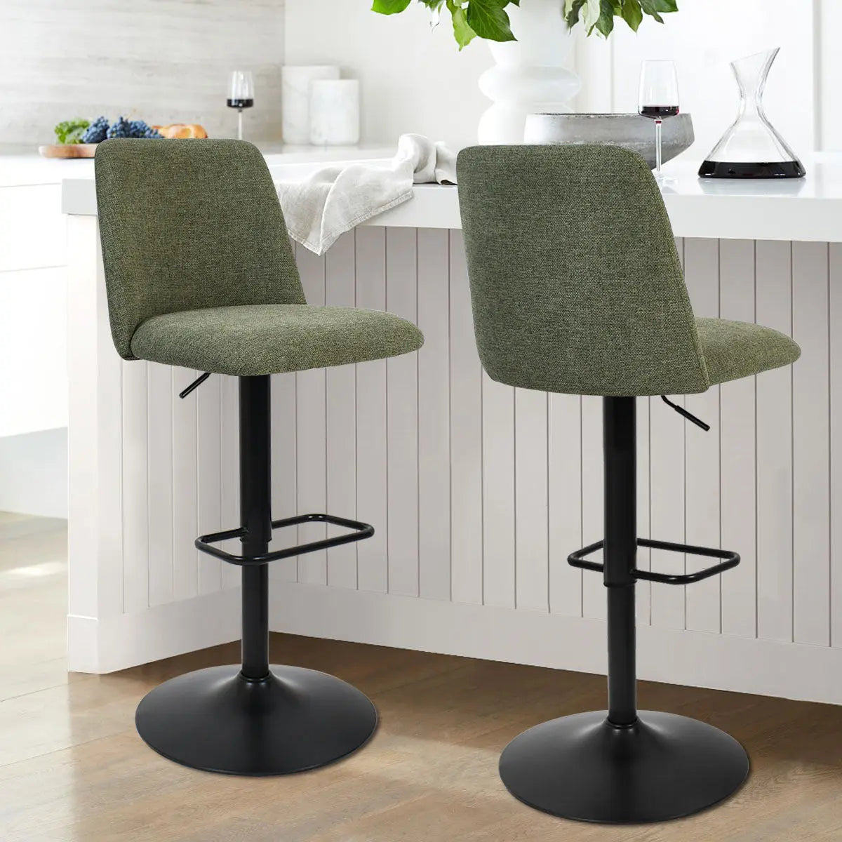 Bruno Modern Upholstered Swivel Stool with olive green fabric in a contemporary kitchen setting.