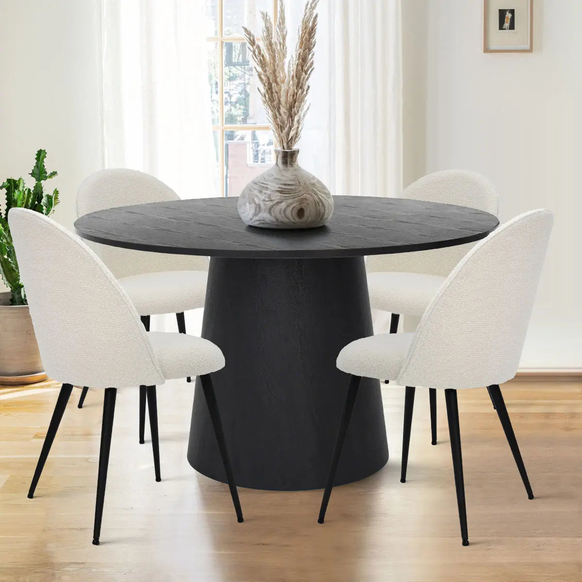 Dwen & Rhon dining table set with white chairs, light wood flooring, bright room, subtle decor.