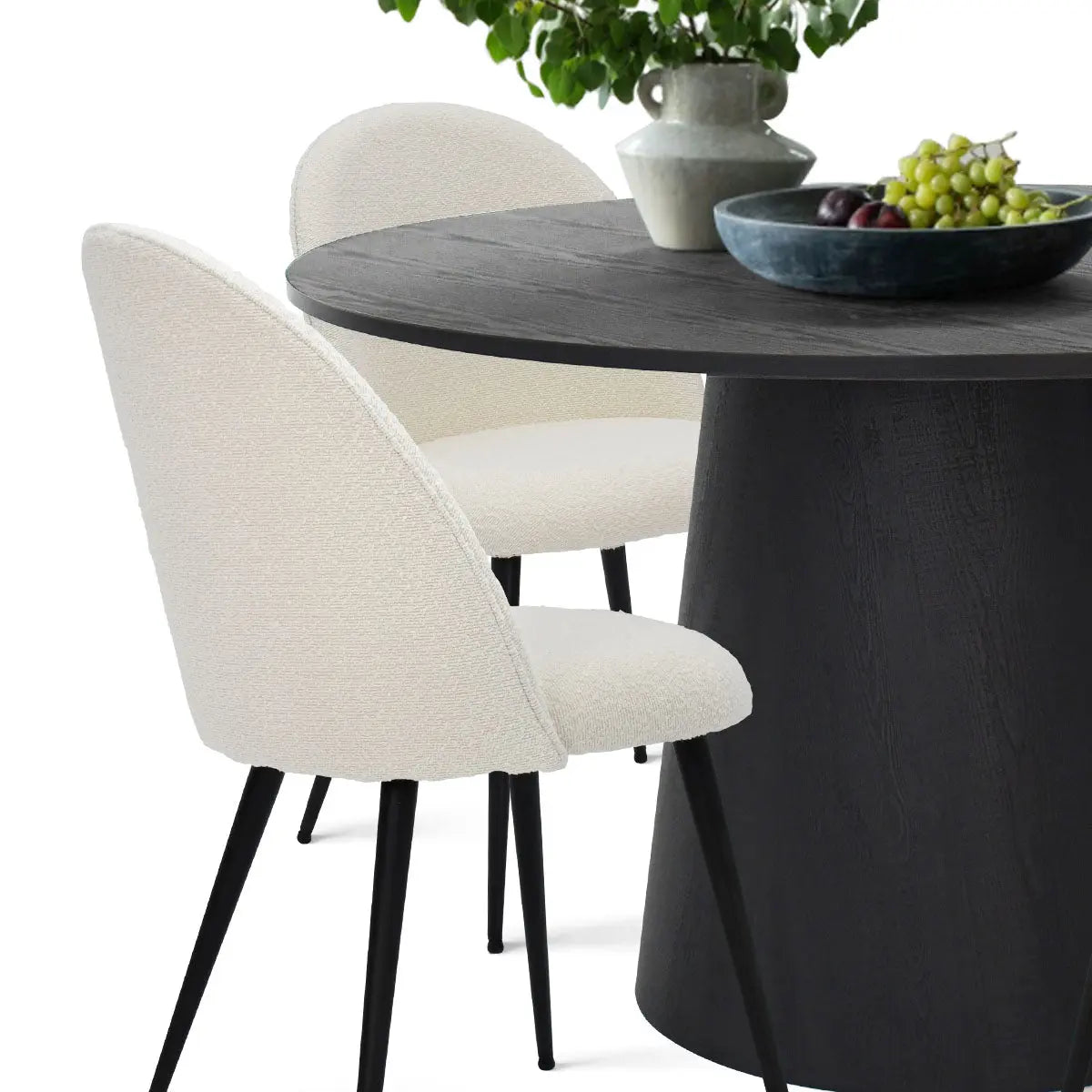 Dwen & Rhon black round pedestal dining table with white chairs, modern style.