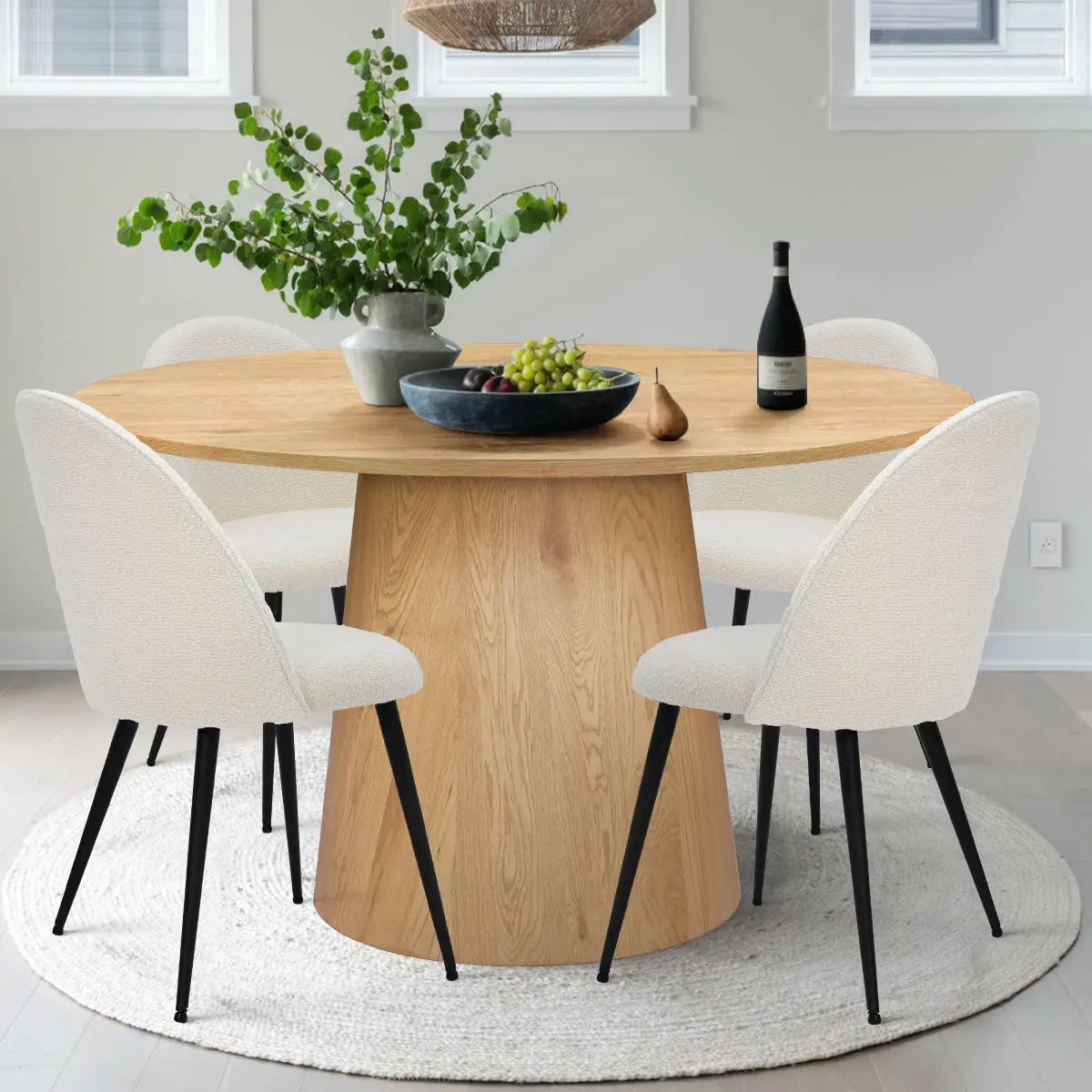 Dwen & Rhon round dining set with oak pedestal, white chairs, light gray walls, modern dining room.