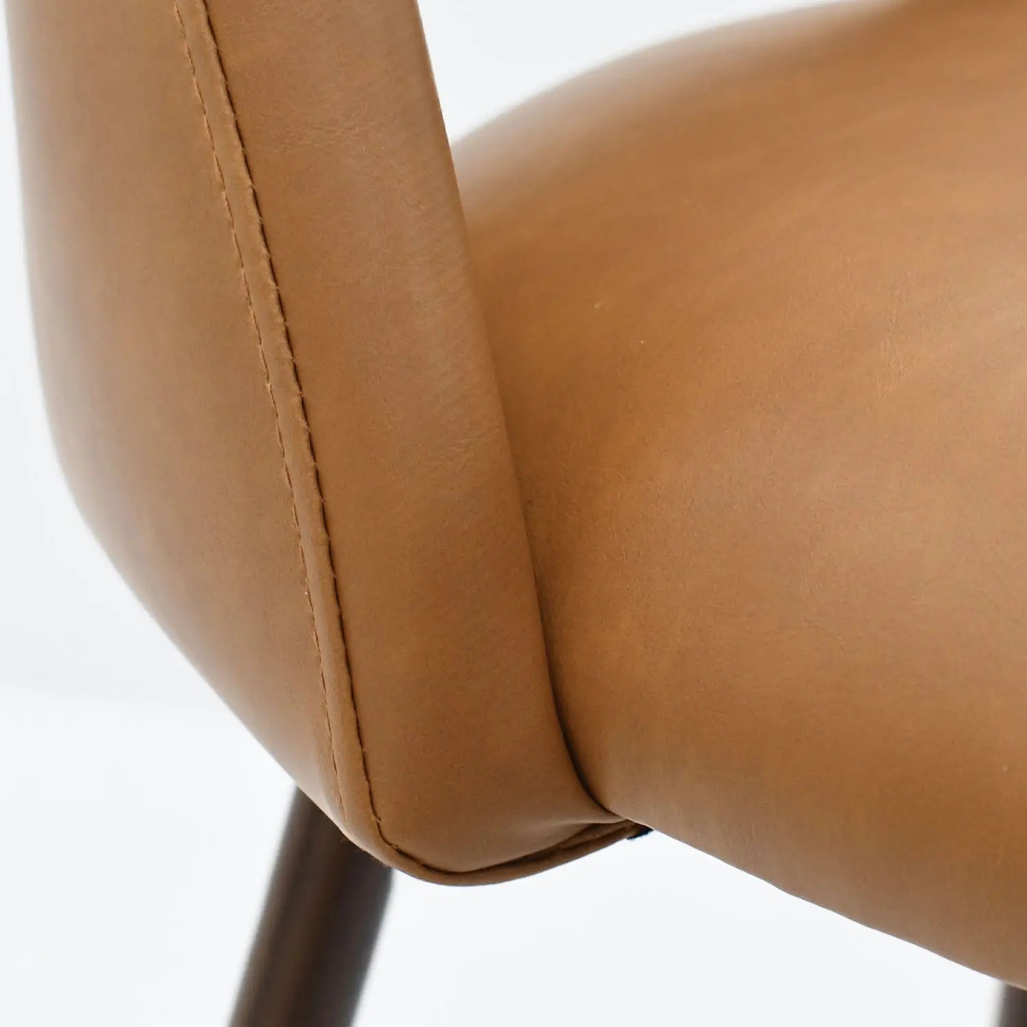 Close-up of Edwin Modern Leather Counter Stool in tan, highlighting texture and stitching details.