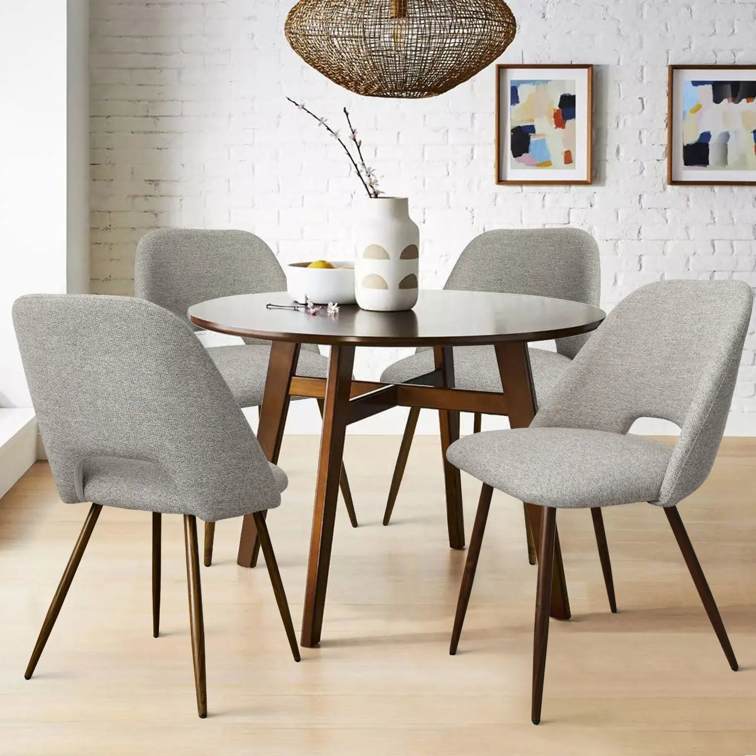 Edwin Modern Boucle Dining Chair set, round wooden table, light wood flooring, white brick wall.