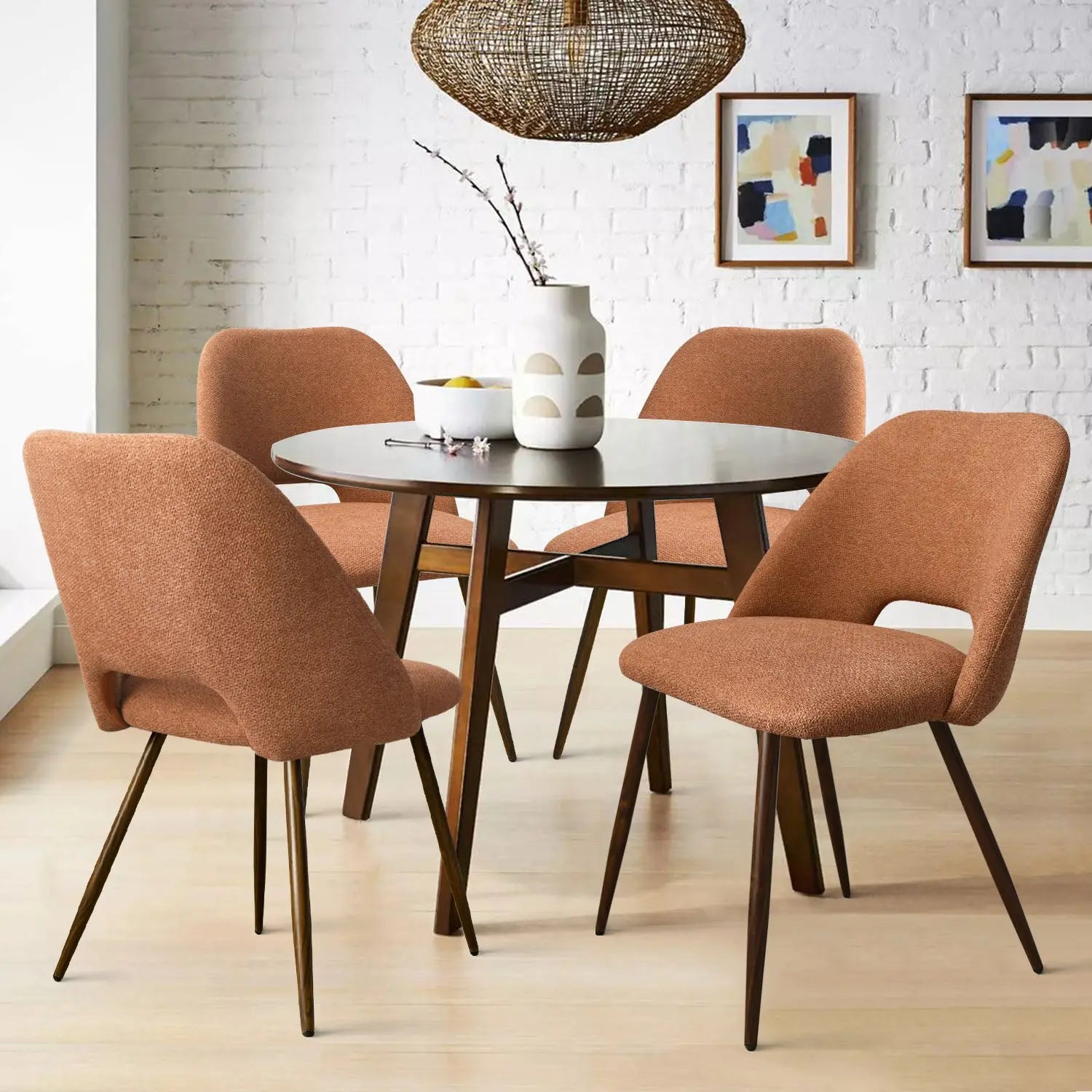 Edwin Modern Boucle Dining Chair set with round table, white brick wall, and wood flooring.