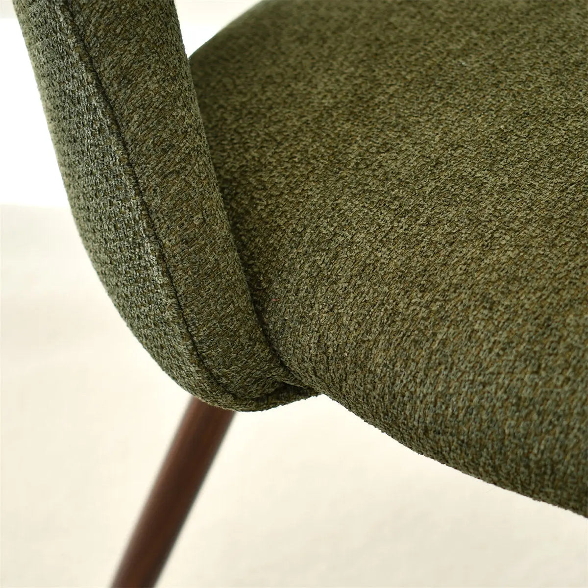 Edwin Modern Boucle Upholstered Dining Chair close-up, fabric detail with cushion and wooden leg visible.