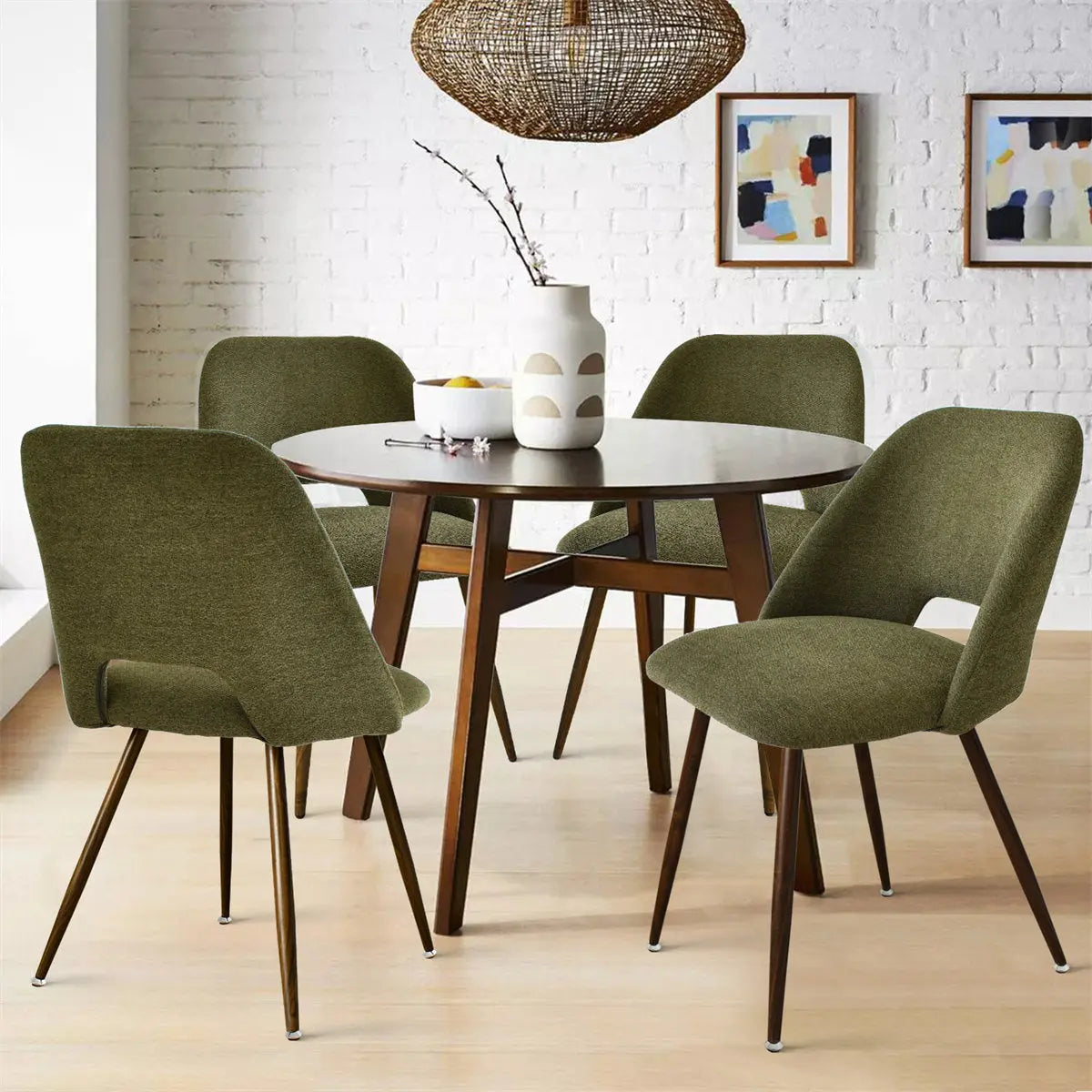 Edwin dining chairs with boucle upholstery around wooden table, white brick wall, light wood flooring.