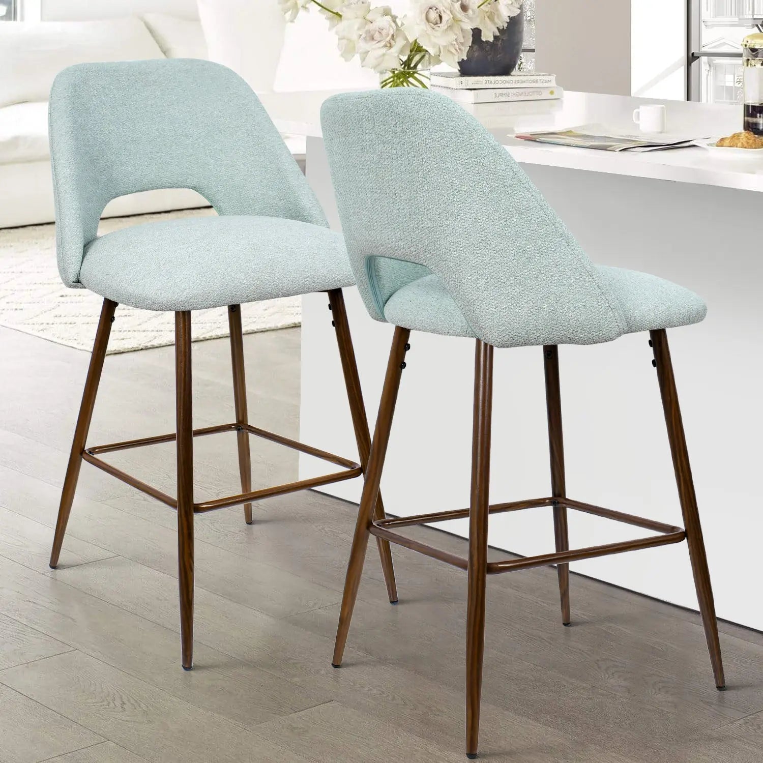 Modern Edwin Upholstered Counter Stool, light wood flooring, neutral living room, white countertop in background.