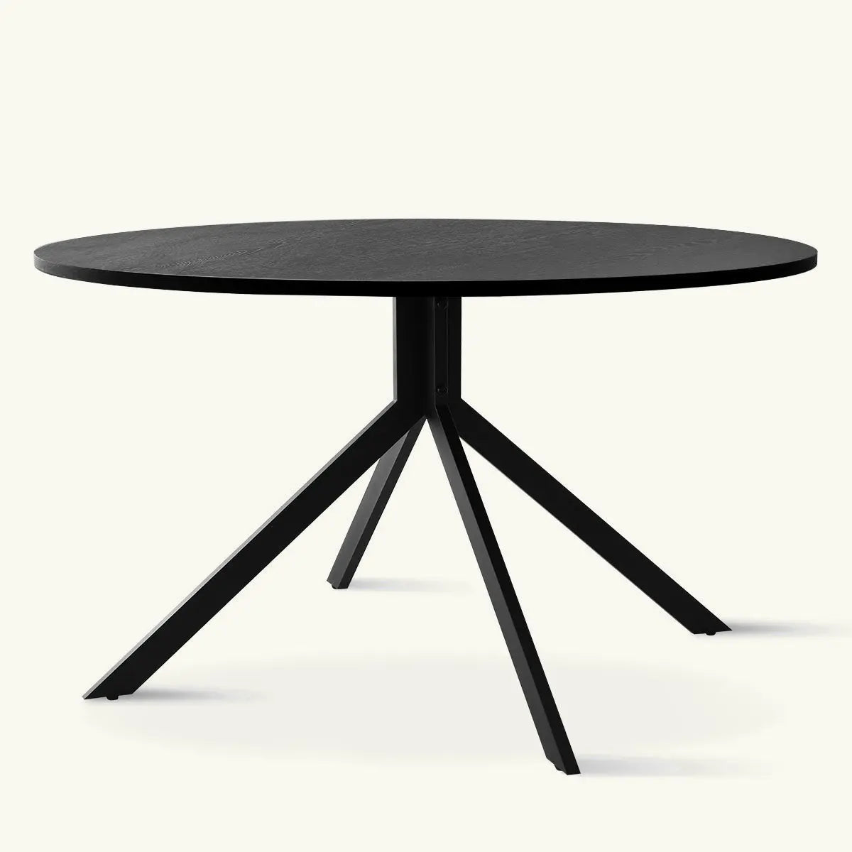 Jones Modern Black Round Dining Table with sleek metal legs, perfect for contemporary dining spaces.