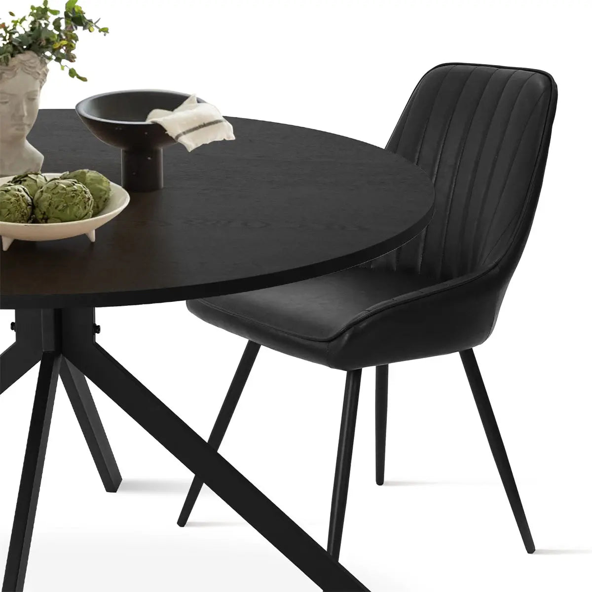 Jonesbo & Boston black round dining table and leather chair set with modern design elements.