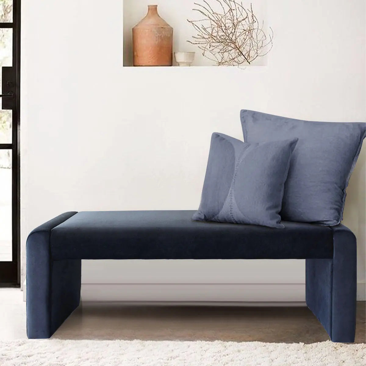 Kaia Modern Leather & Velvet Waterfall Bench in neutral room, with pillows on beige carpet flooring.