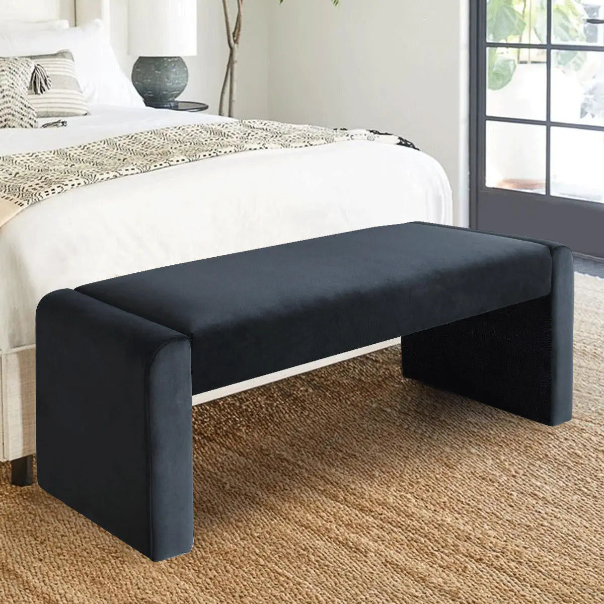 Kaia Modern Leather Velvet Waterfall Bench in bedroom with textured carpet flooring and white bedding.