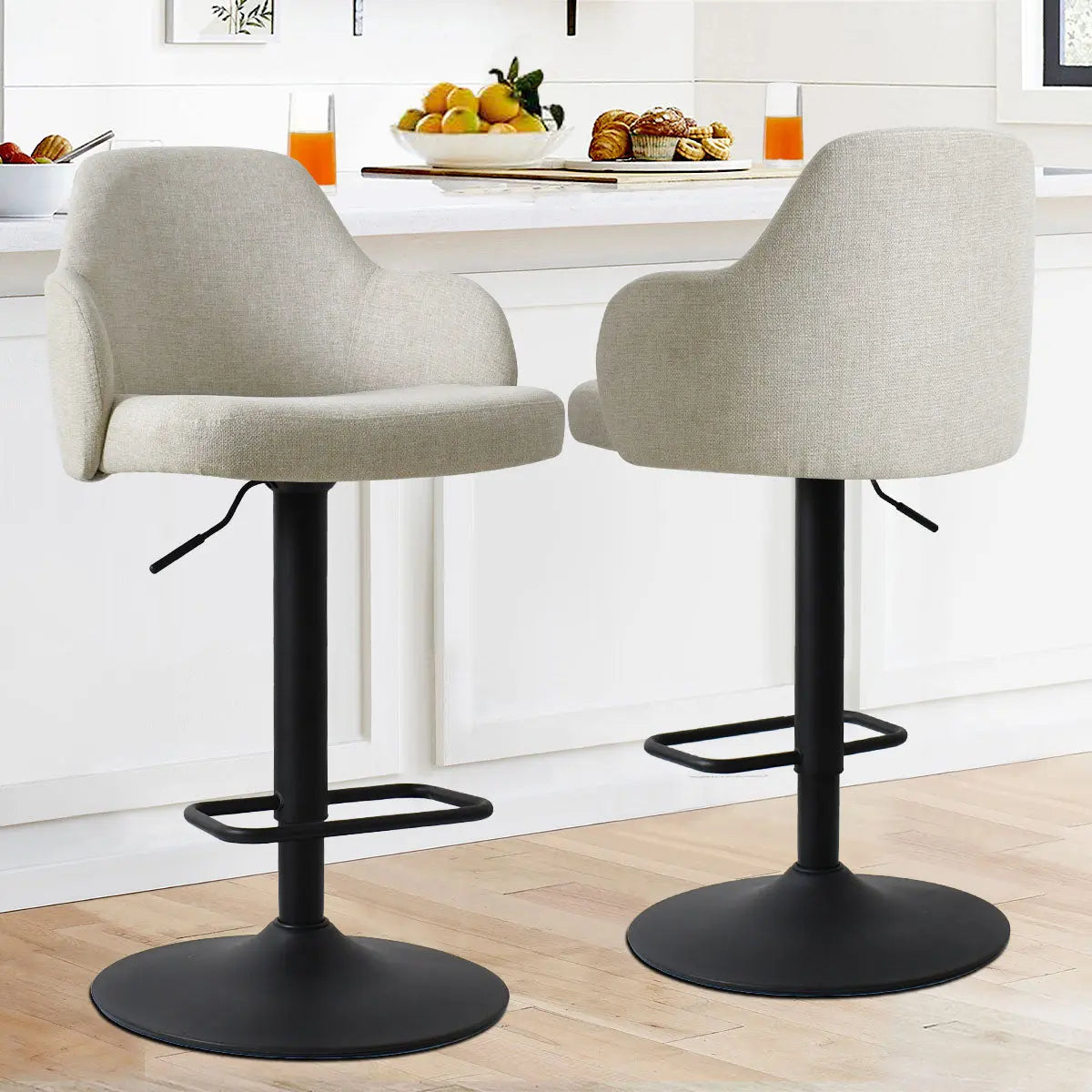 Mars Upholstered Swivel Stool with Arms in modern kitchen; light wood flooring, white cabinetry.