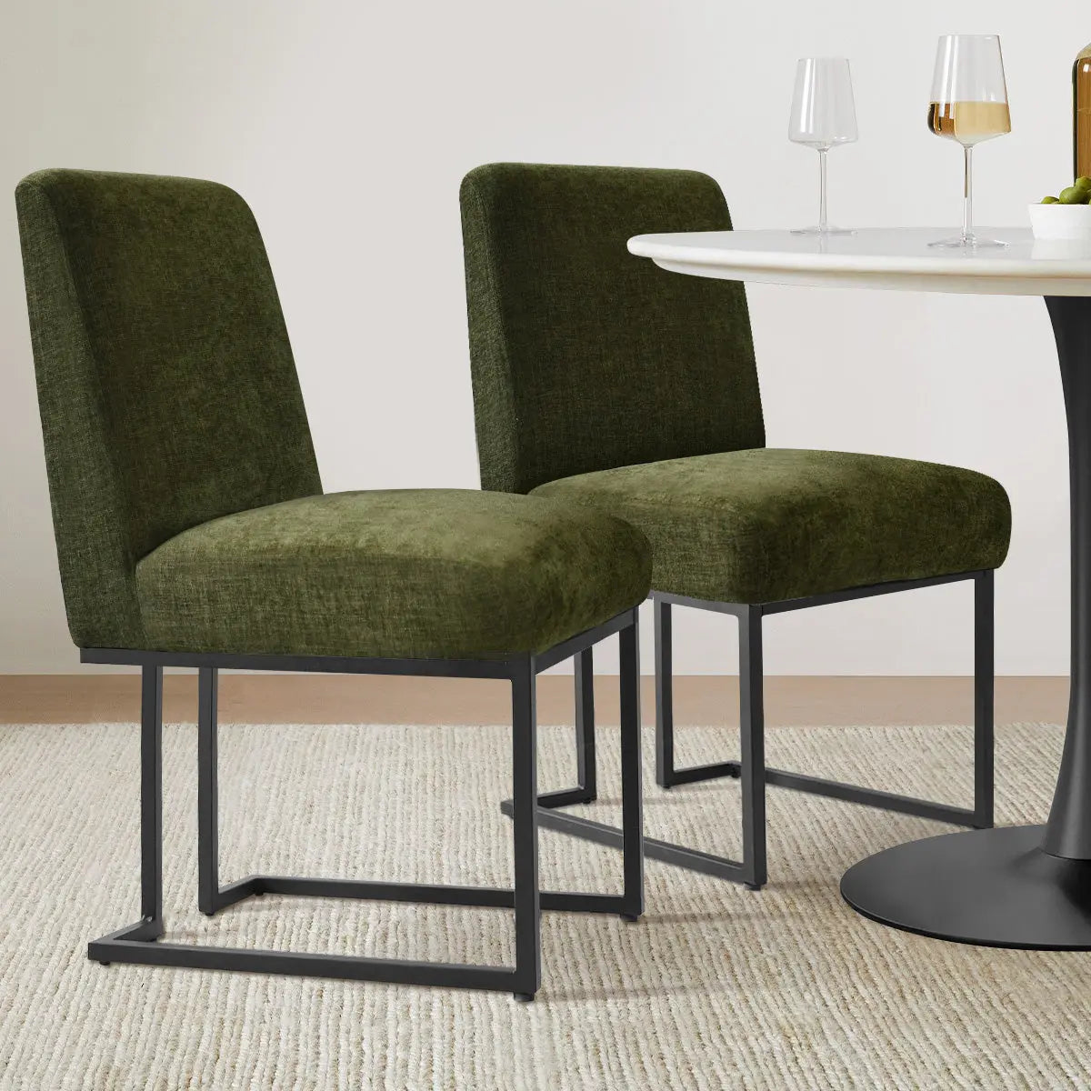 Mason Modern Metal Frame Dining Chair in green, dining room setting with round table, neutral rug.