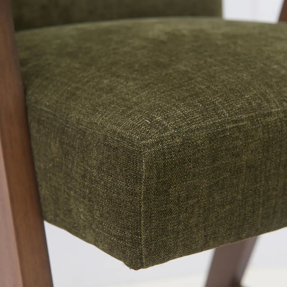 Close-up of Morgan Mid Century Modern green upholstered counter stool seat with wooden legs.