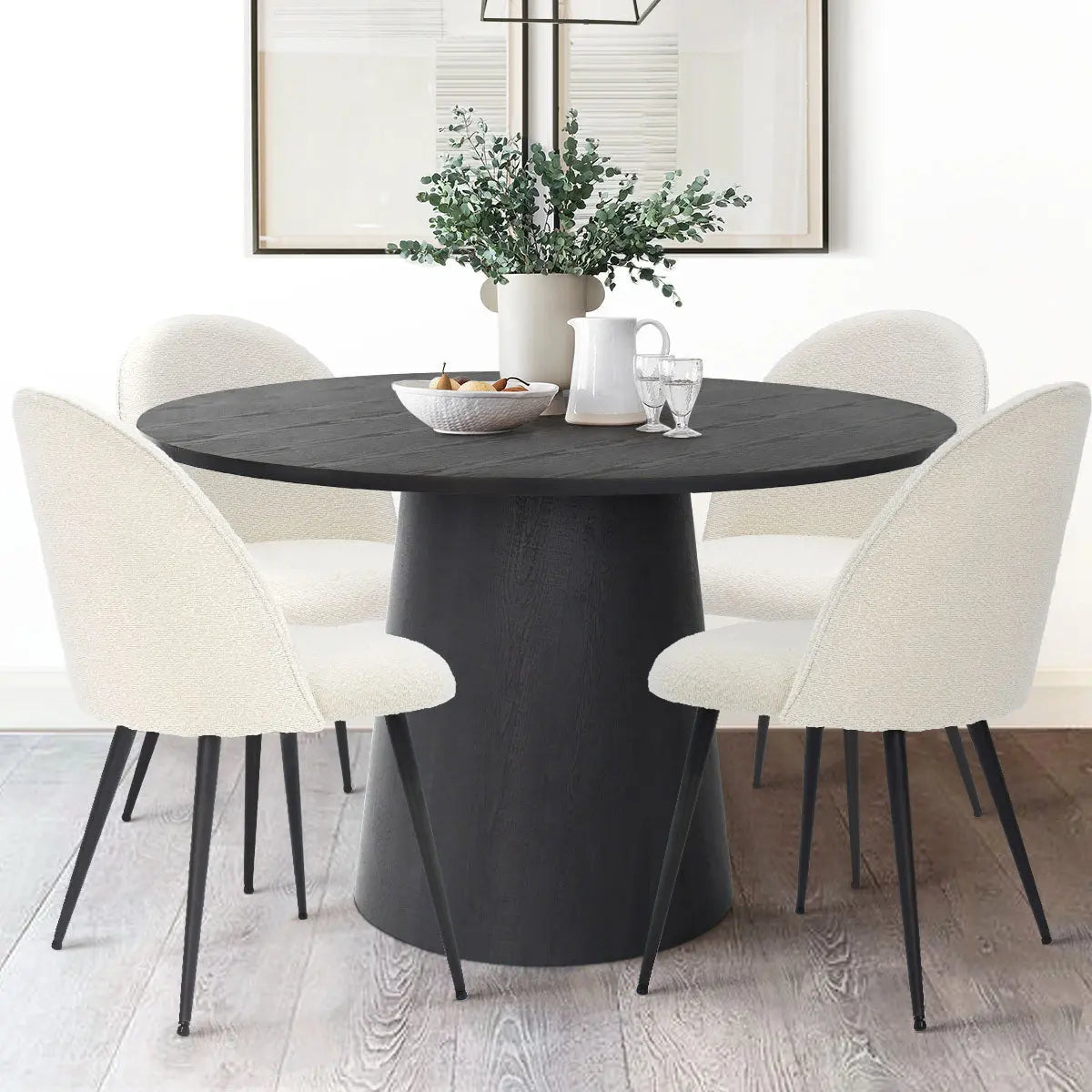 Rhon Modern Boucle Upholstered Dining Chair set around black table on light wood flooring.