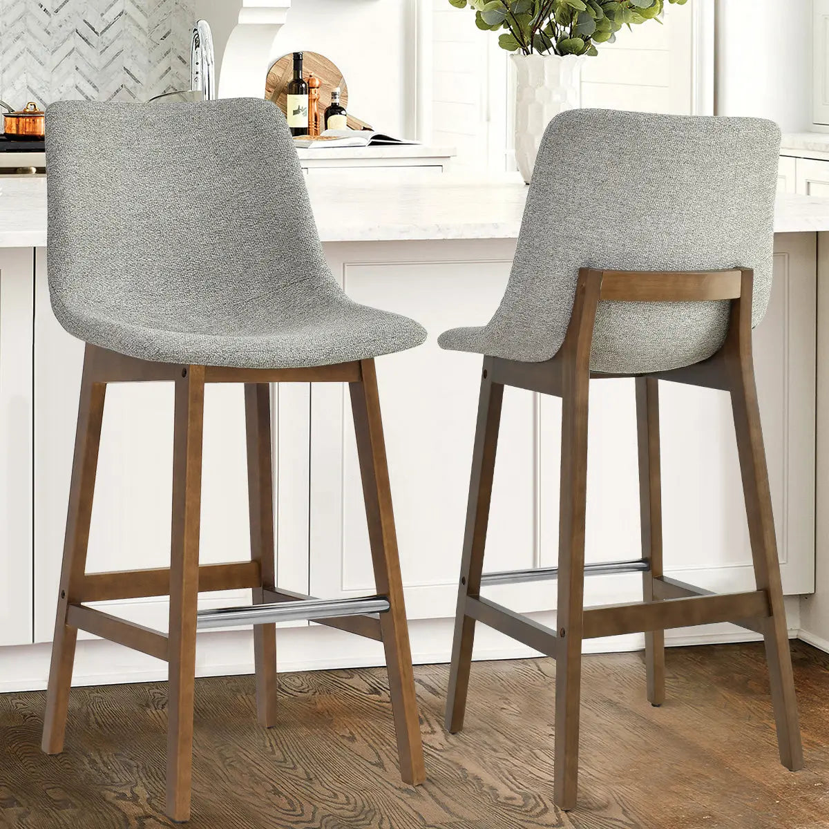 South Modern Upholstered Counter Stool, gray upholstery, wooden legs, kitchen setting, hardwood flooring.