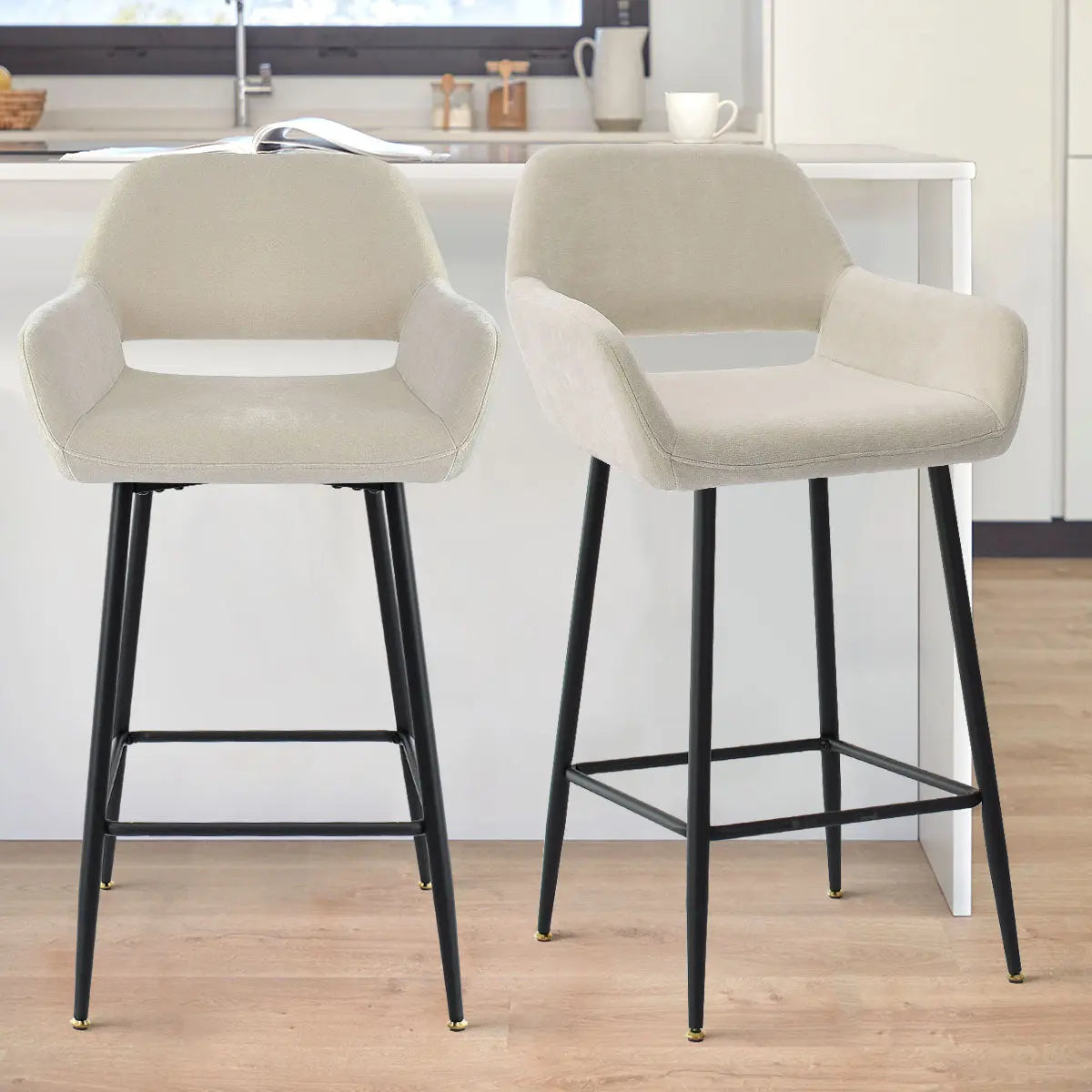 William Modern Upholstered Counter Stool with Arms, beige, black legs, kitchen island, wooden floor.